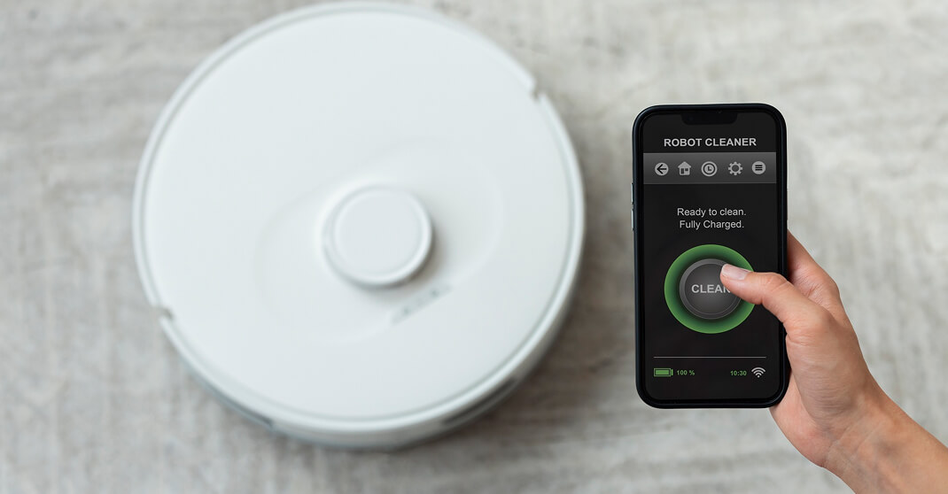 Roboterstaubsauger auf Teppich mit Smartphone-Steuerung Robot Cleaner App
